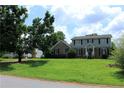 Charming two-story home with a well-maintained lawn and mature trees surrounding the property at 4814 Delgado Dr Sw, Lilburn, GA 30047