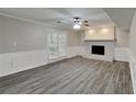 The finished basement boasts new floors, wainscotting, and a charming painted brick fireplace with a door to the backyard at 650 Lake Forest Ct, Roswell, GA 30076