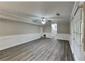 The open basement features new floors, wainscotting, a ceiling fan, and a door to the backyard at 650 Lake Forest Ct, Roswell, GA 30076