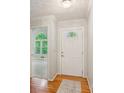 Inviting entryway with hardwood floors and view to living room at 120 Timbervalley Ln, Lawrenceville, GA 30043