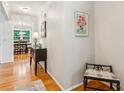 Hallway featuring hardwood floors and views of the dining room beyond at 120 Timbervalley Ln, Lawrenceville, GA 30043
