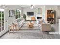 Bright, staged living room features fireplace, neutral walls, and stylish furniture at 2438 Suwanee Pointe Dr, Lawrenceville, GA 30043