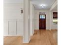 Bright foyer features hardwood floors, white trim, and a shiplap accent wall with a dark wood front door at 3278 Shakerley Park, Douglasville, GA 30135