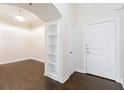 Elegant entryway features hardwood floors, built-in shelving, and a modern chandelier at 3445 Stratford Ne Rd # 3403, Atlanta, GA 30326