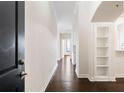 Bright hallway featuring hardwood floors and built-in shelving at 3445 Stratford Ne Rd # 3403, Atlanta, GA 30326