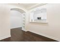 Open living space with hardwood floors, archway, and view of the kitchen at 3445 Stratford Ne Rd # 3403, Atlanta, GA 30326