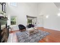Bright living room with hardwood floors, a fireplace, and large bay window provides natural light at 350 Eagle Tiff Dr, Sugar Hill, GA 30518