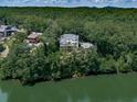 Beautiful home nestled among lush trees on a waterfront property, offering privacy and scenic views of the lake at 7560 Island Mill Rd, Acworth, GA 30102
