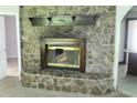 A close-up view of the living room's large stone fireplace with a wood mantel at 2842 Jordan Forest Trail Northwest, Lawrenceville, GA 30044