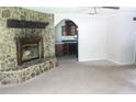 Spacious living room with carpet floors, a stone fireplace, and a view of the kitchen at 2842 Jordan Forest Trail Northwest, Lawrenceville, GA 30044
