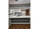 Bright kitchen featuring white cabinets, a modern backsplash, stainless appliances, and a center island with seating at 31 Country Place Ct, Alpharetta, GA 30005