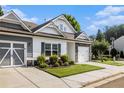 Attractive townhome exterior with neat landscaping, multi-car parking, and a well-kept lawn at 111 Point View Dr, Canton, GA 30114