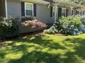 Landscaped front yard features a manicured lawn, plants, and shrubbery at 2832 Jordan Forest Trail Northwest, Lawrenceville, GA 30044