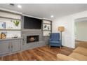 Cozy living room with a fireplace, built-in shelves, and hardwood floors at 3375 Rivendell Ct, Roswell, GA 30075