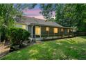 The backyard features a screened in porch, mature trees, and green grass at 3997 Paloverde Nw Dr, Kennesaw, GA 30144