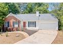 Charming one-story home with brick and vinyl siding, a well-manicured lawn, and a concrete driveway at 3997 Paloverde Nw Dr, Kennesaw, GA 30144
