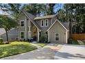Charming two-story home with a stone accent facade, complemented by a well-manicured lawn and a modern driveway at 5086 N Woodbridge Trl, Stone Mountain, GA 30088