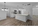 Bright kitchen features white cabinets, stainless appliances, and a marble countertop island at 1644 Royal Ives Dr, Lawrenceville, GA 30045