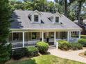 Inviting front porch with white columns on a beautiful home exterior at 1772 Ridgewood Ne Dr, Atlanta, GA 30307