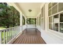 Relaxing covered front porch with swing and view of the wooded front yard at 1772 Ridgewood Ne Dr, Atlanta, GA 30307