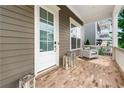 Inviting front porch with brick flooring, white railings, a seating area, and a view of the neighborhood at 310 Braeden Way, Alpharetta, GA 30009