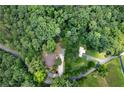 Aerial view showcasing the property's wooded lot, proximity to the road, and detached garage at 528 Pumpkinvine Rd, Acworth, GA 30101