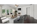 Bright living room with hardwood floors, fireplace, and comfortable seating at 6755 Waveland Dr, Cumming, GA 30040