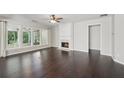Bright living room with hardwood floors, fireplace, and plenty of natural light at 6755 Waveland Dr, Cumming, GA 30040