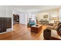 Inviting living room featuring hardwood floors, cozy furniture, and a view into dining area at 5623 Crestwood Dr, Stone Mountain, GA 30087