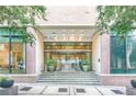 Building entrance with '300' address, glass doors, and stone stairs at 300 Peachtree St # Apt 9D, Atlanta, GA 30308