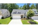 Beautiful view of a two-story home, featuring a two-car garage, dormer windows, and a well-manicured lawn at 4554 Grenadine Cir, Acworth, GA 30101