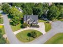 Aerial view of a landscaped home featuring manicured lawns, mature trees, and a circular driveway at 801 Windsor Rdg, Canton, GA 30115