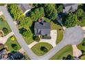 Aerial view of a landscaped home showcasing its circular driveway, mature trees, and backyard deck at 801 Windsor Rdg, Canton, GA 30115