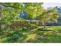 Charming single Gathering home with brick accents, a well-manicured lawn, and mature landscaping at 1646 Rainier Falls Ne Dr, Atlanta, GA 30329