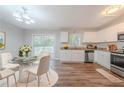 Eat-in kitchen with stainless appliances, granite counters, white cabinets, and a sliding door to the deck at 1658 Pine Glen Cir, Decatur, GA 30035