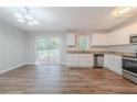 Kitchen with stainless appliances, granite counters, white cabinets, and a sliding door to the deck at 1658 Pine Glen Cir, Decatur, GA 30035