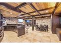 Finished basement with bar, stone accent walls, coffered wood ceiling and dining area for entertaining at 4317 Oglethorpe Nw Loop, Acworth, GA 30101