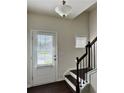 Bright entry foyer with dark wood staircase, white trim, and a door with window and blinds at 1452 Ridgebend Se Way, Mableton, GA 30126