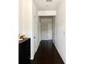 Long, well-lit hallway with dark wood floors and white walls leading to multiple rooms at 1452 Ridgebend Se Way, Mableton, GA 30126