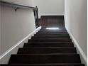 Dark wood staircase with white risers, offering a clear path to the upper level of the home at 1452 Ridgebend Se Way, Mableton, GA 30126