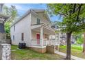 Side view of a beige two-story home with a welcoming front porch and green lawn at 639 Ira Sw St, Atlanta, GA 30312
