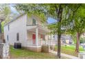 Side view of a beige two-story home with a welcoming front porch and green lawn at 639 Ira Sw St, Atlanta, GA 30312