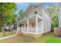Charming two-story home featuring a welcoming front porch and a vibrant red front door at 639 Ira Sw St, Atlanta, GA 30312