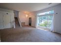 Open entryway featuring staircase, chandelier, and a large window providing plenty of natural light at 7472 Woods Ct, Lithonia, GA 30058