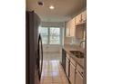 Kitchen with stainless steel refrigerator, stone countertops, white subway tile backsplash, and dining area at 1120 Brandon Hill Way, Jonesboro, GA 30238