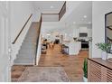 Open-concept interior with a staircase, modern kitchen, and a cozy living area at 2703 Jordan Ln, Lithia Springs, GA 30122