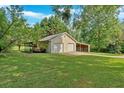 Detached outbuilding with a two-car garage and covered parking at 3122 Harmony Rd, Temple, GA 30179