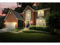 Charming two-story brick home featuring an inviting front yard and an attached two-car garage at 4138 Glenlake Nw Ter, Kennesaw, GA 30144