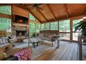 Inviting sunroom with wood plank flooring and ceiling, a stone fireplace, and comfortable seating at 4138 Glenlake Nw Ter, Kennesaw, GA 30144