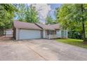 Inviting single-story home features a spacious driveway, attached garage, and welcoming front porch at 45 Kelsey Way, Palmetto, GA 30268